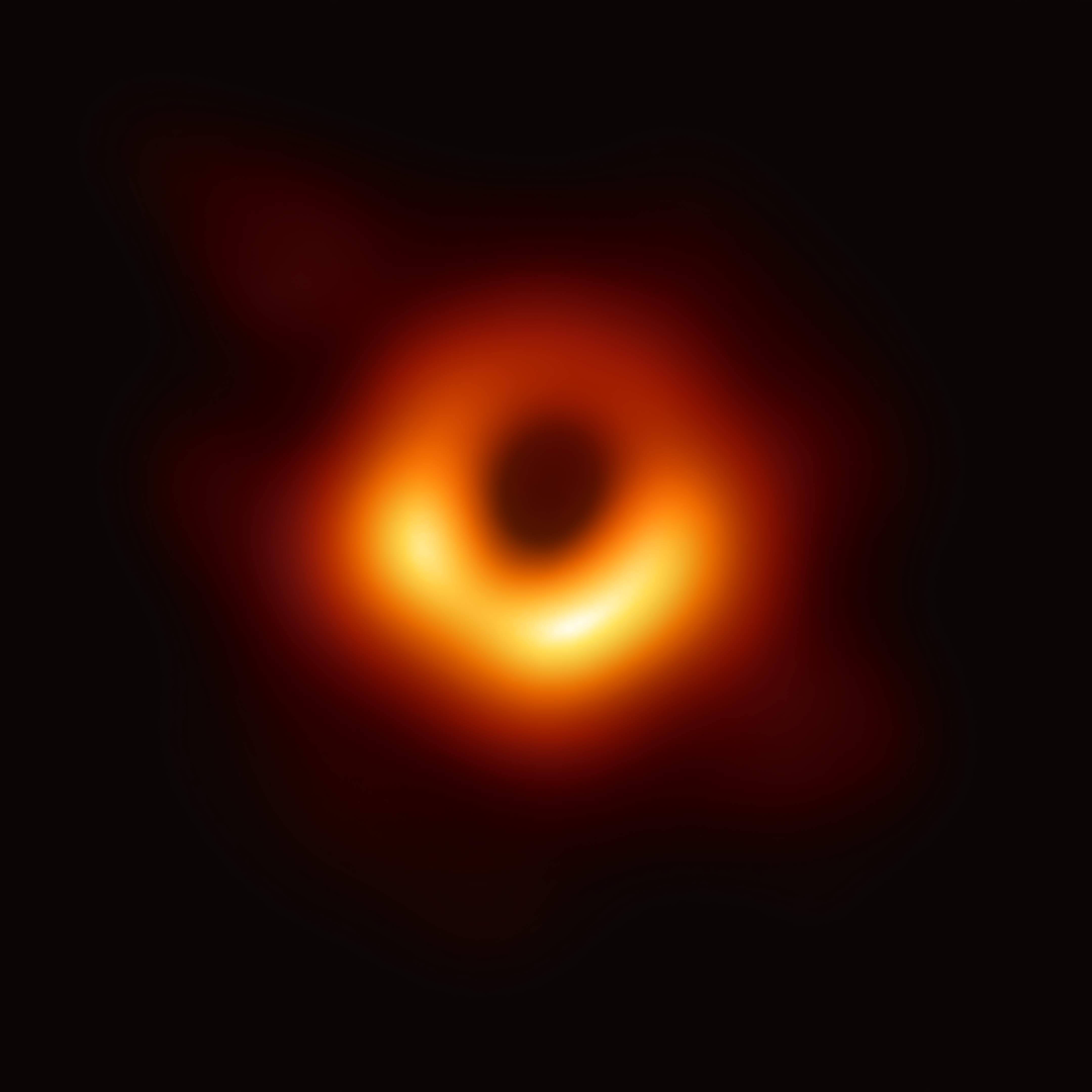 Der Schatten des Schwarzen Lochs M87* und die
     rotierende Gasscheibe, die unten auf uns zu kommt, und daher
     heller ist.
     (<a
     href='https://commons.wikimedia.org/w/index.php?curid=77925953'>NASA,
      ESO Article, ESO TIF, CC BY 4.0</a>)